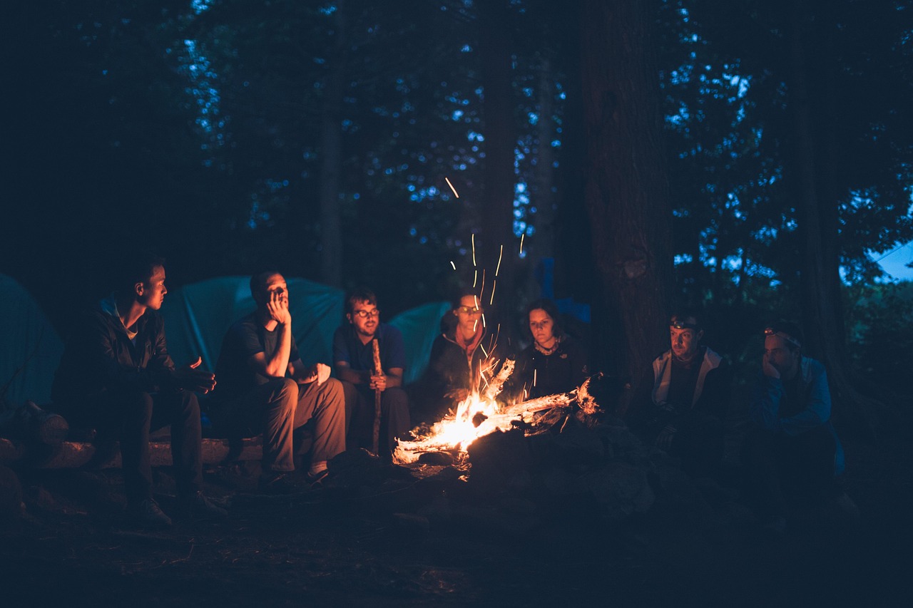 men around campfire at night